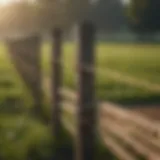 Rope fence post installation in a lush agricultural field